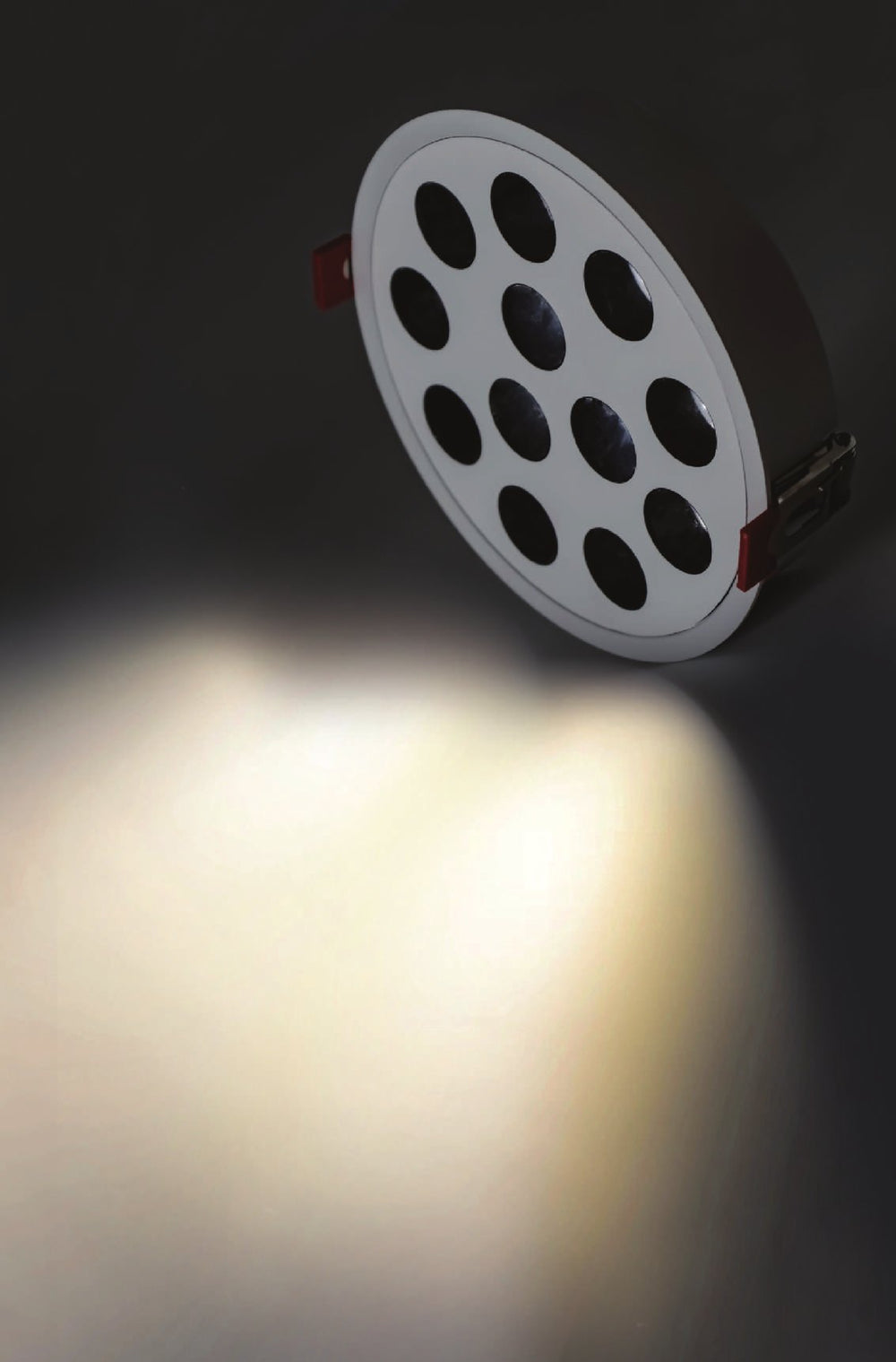 A lit recessed downlight with twelve lenses
