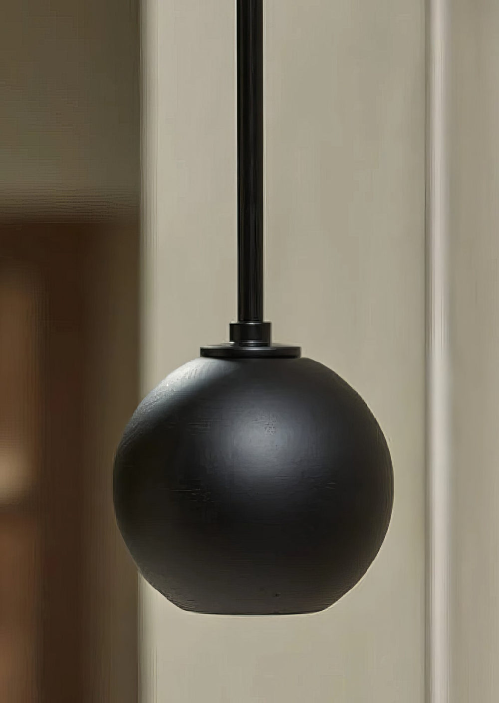 A black ball pendant on a magnetic track