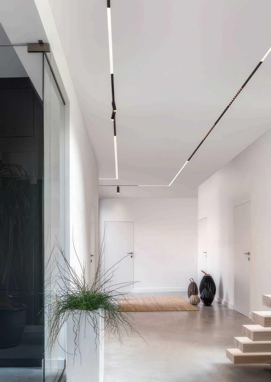 Magnetic track lights in a white corridor